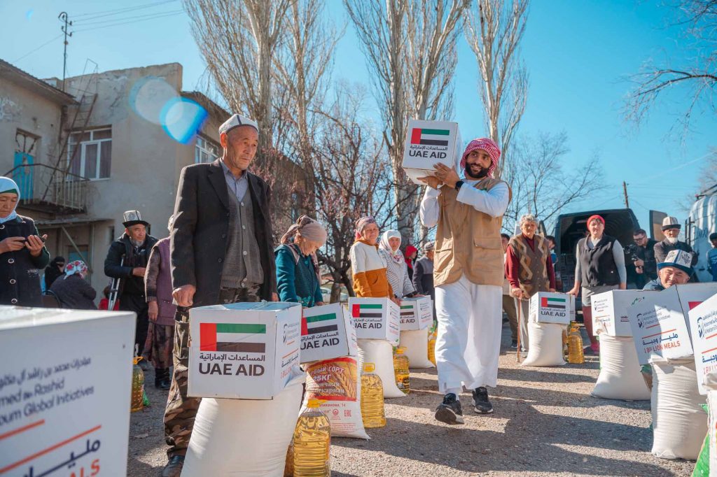 A group of people receiving the UAE AID