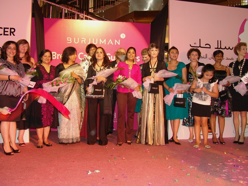 A group of women holding bouquets of flowers