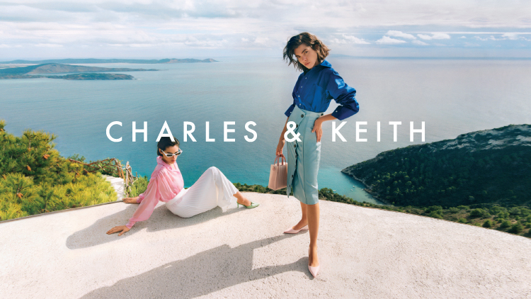 Two women modelling Charles & Keith on a sea view