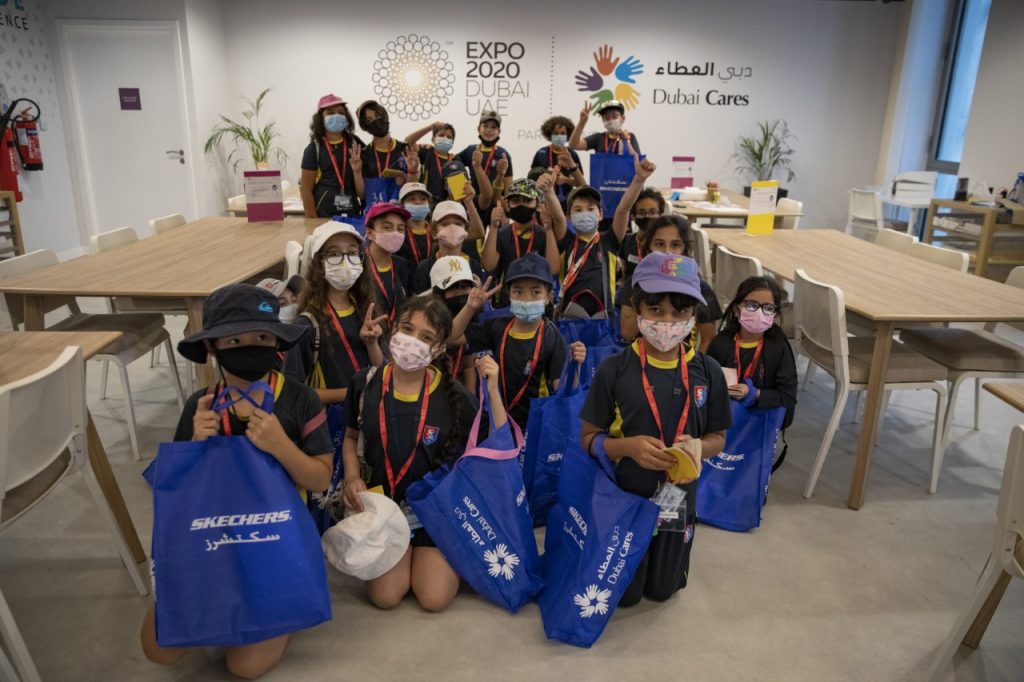 A group of kids wearing masks and carrying Skechers bags