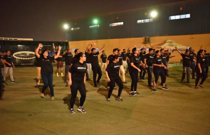 A group of people in black doing exercises outside