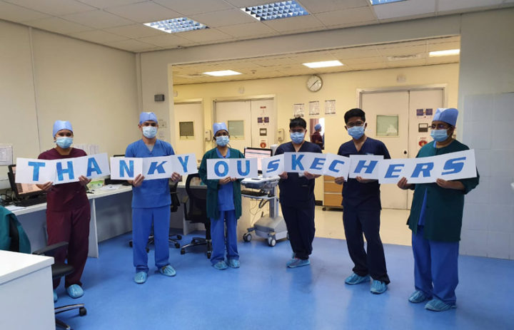 Healthcare workers holding a thank you sign for Skechers