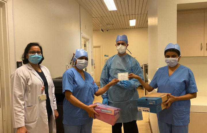 A medical team of four receiving Skechers gifts