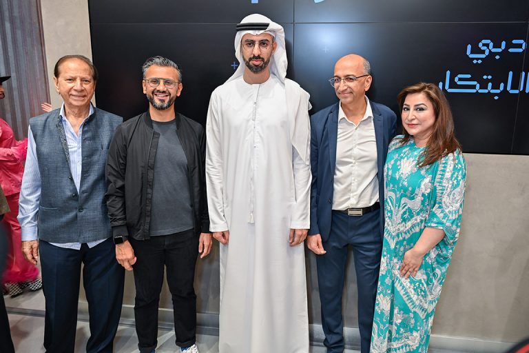 Four men and a women gathered in the opening of phygital store