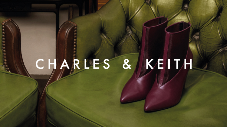 Purple high heels boots of Charles & Keith on the couch