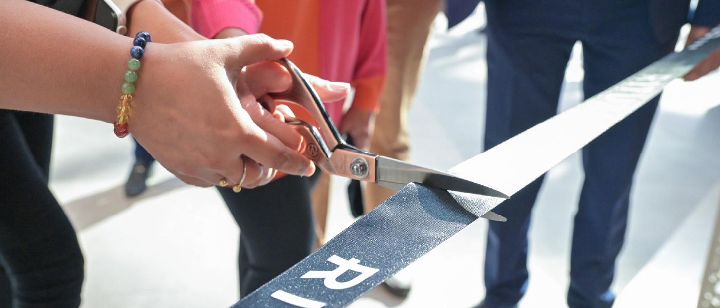 Hands with the scissors cutting the tape