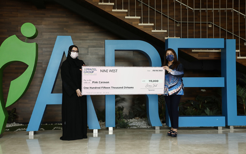 Two women holding cheque of Nine West