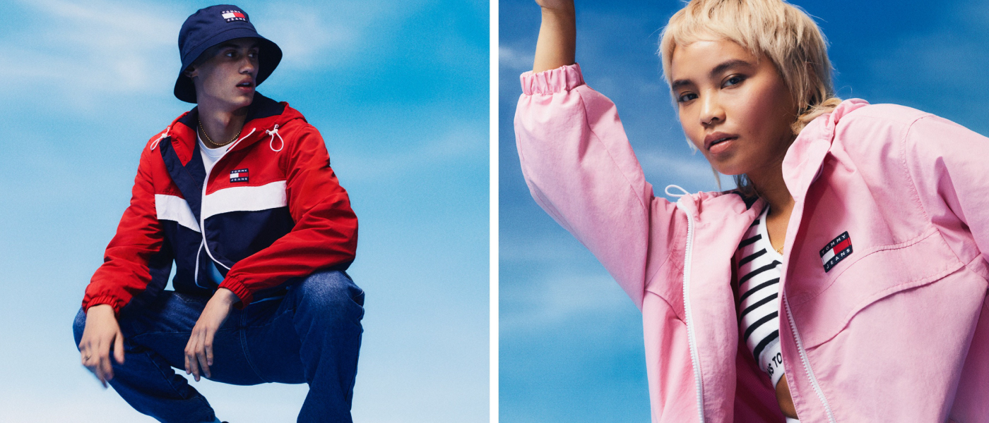 A young woman and a young man are showing Tommy Jeans clothes