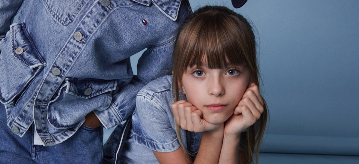 A girl wearing a denim outfit from Tommy Hilfiger Kids