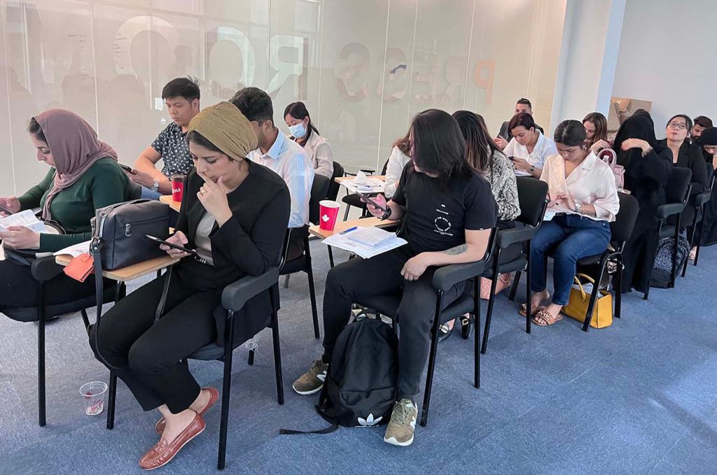 A group of students sitting in the class of Apparel Digital Learning Academy