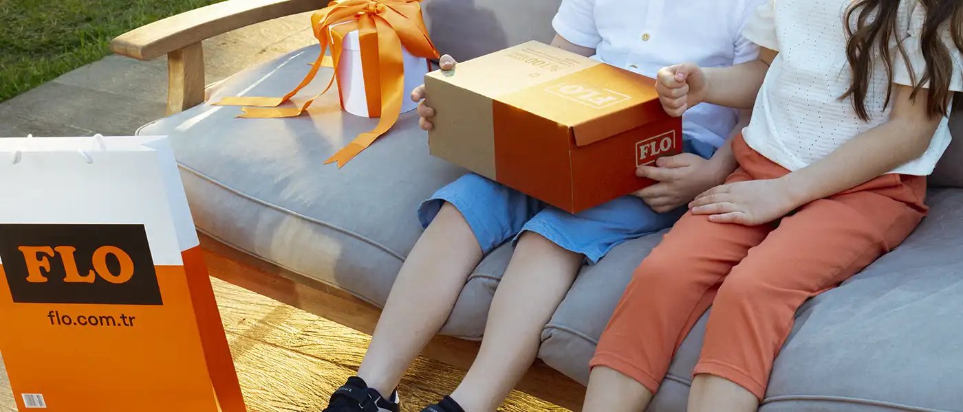 Two kids opening FLO shoes box