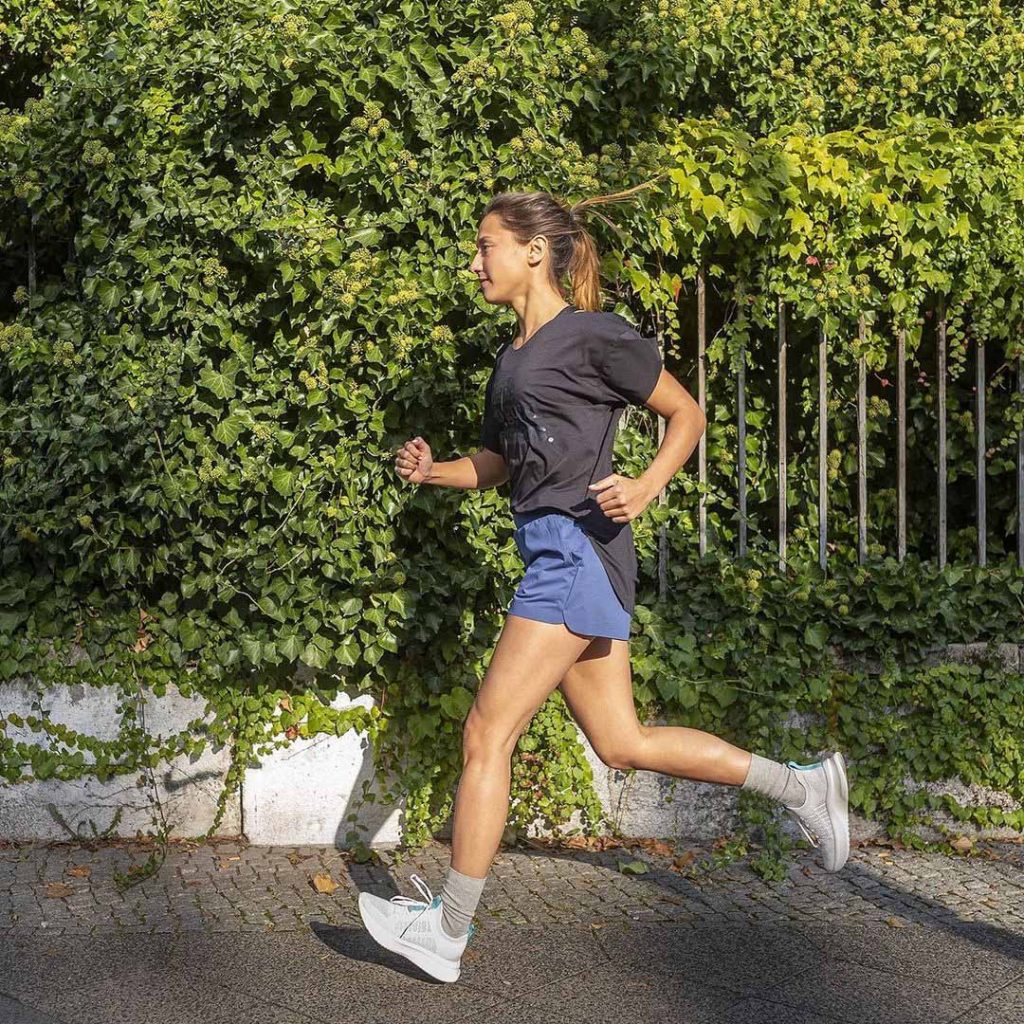 A woman running wearing F5 global shoes