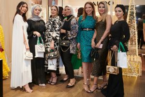 A group of stylish ladies holding ALDO bags