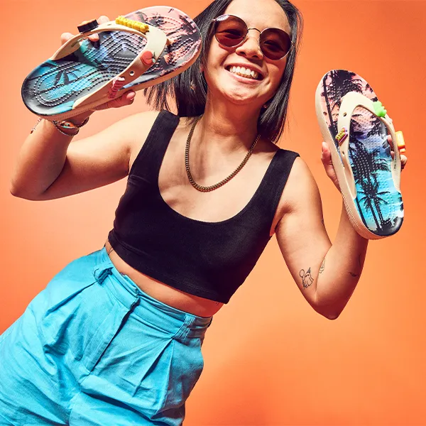 A woman holding Crocs Flip Flops