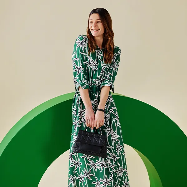 A woman wearing a green evening dress from LC Waikiki