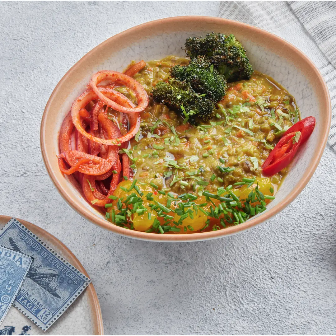 A Bowl of Lentil, Broccoli, Passion Fruit, and Grilled Vegetables