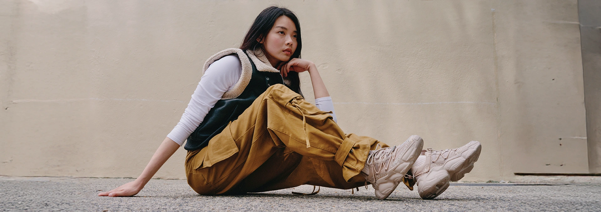 Woman sitting on the floor wearing Steve Madden shoes